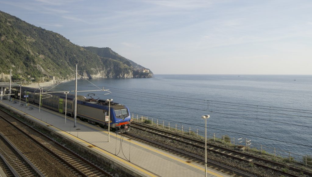 Train passing along the coastline in Cinque Terre Italy
