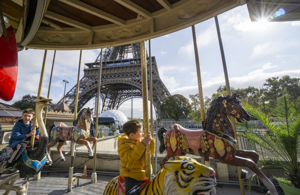 Carousel ride near Eiffel Tower Paris with kids